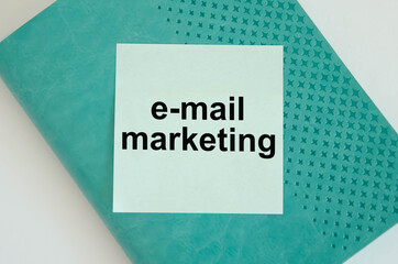  text e-mail marketing written on a blue background and notepad