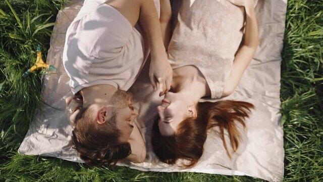 Young husband and wife relax together in the garden