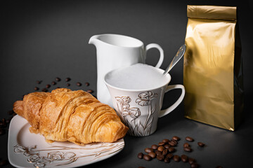 Coffee pouch mockup with croissant and milk in beans on dark romantic blue background. Gold paper clear bag