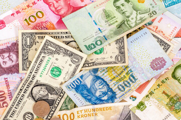 Fototapeta na wymiar Concept photo for international currency exchange and different currencies. U.S. Dollars, Chinese Yuan, Hungarian Forints, Danish Kroner and Thai Baht pictured.