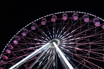 luminous ferris wheel against the night sky.