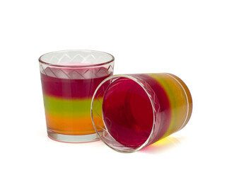 Two glasses with tricolor jelly isolated on white background