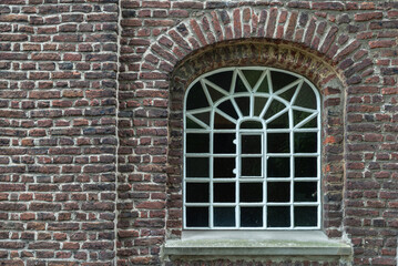Old lattice window in the old brick wall