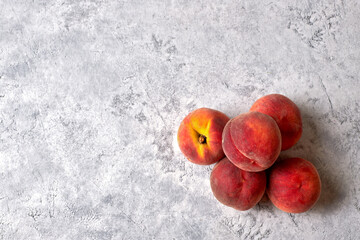 Five ripe, juicy peaches, on a white spotted background