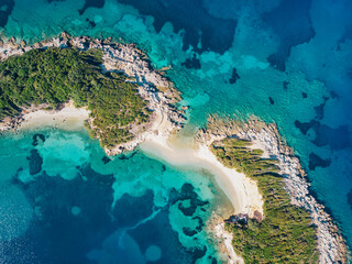 Aerial view of a beautiful deserted island in the turquoise sea. Drone shot.