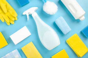 Detergents and cleaning products agent, sponges, napkins and rubber gloves, blue background. Top view