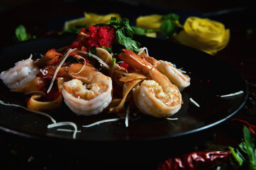 Organic spicy pasta prawn or shrimp tobiko with basil, black pepper and dry pasta in the background