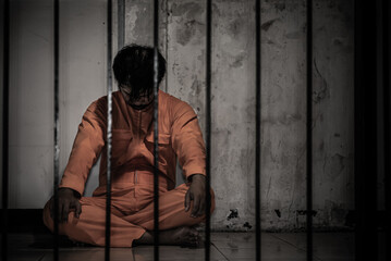 Asian man desperate at the iron prison,prisoner concept,thailand people,Hope to be free,Serious...