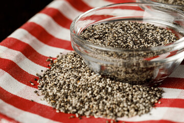 Glass bowl with chia seeds on wooden table
