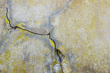 Cracked cement wall, detail of a wall damaged by the passage of time