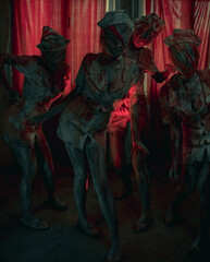 Cosplayers are in image of monsters mannequins.