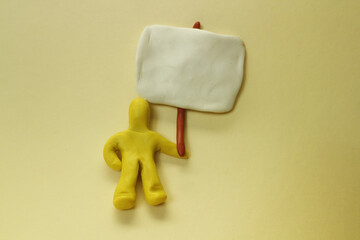 Plasticine yellow man with a banner.