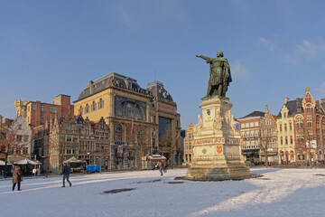 Friday market square, with statue of Jacob van Artevelde, medieval guild houses now housing bars and restaurants on a sunny winter day with snow in Ghent, Flanders, Belgium 