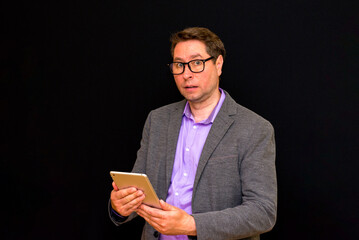 Middle age Business man uses and works with the pc tablet