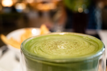cup of matcha milk tea on table