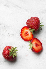 Fresh ripe perfect pieces strawberry on white marble background. Fresh strawberry as texture background. Natural food backdrop with red berries. Strawberries sale in a food market in summer.