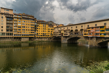 Famous Ponte Vecchio bridge and cityscape view of old town Florence by Arno river in Florence,...