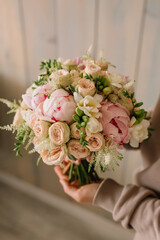Wedding bouquet of delicate roses and peonies for the bride