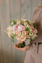 Wedding bouquet of delicate roses and peonies for the bride