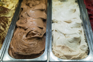 Vanilla and chocolate italian gelato ice cream in the gelato shop, Italy