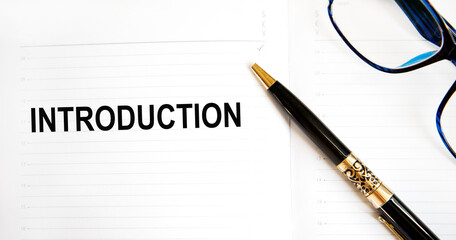 Word Introduction written on paper and a pen