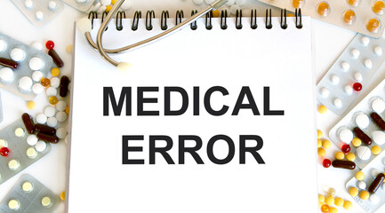 A medical concept. The inscription on the notebook is a medical error. There's a pill and a...
