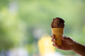 Hand and ice cream quenches thirsty foods that are sweet and tasty.