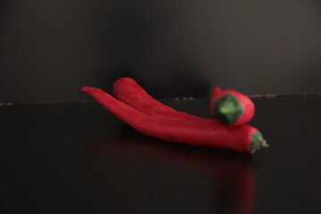 colorful peppers on a black background
