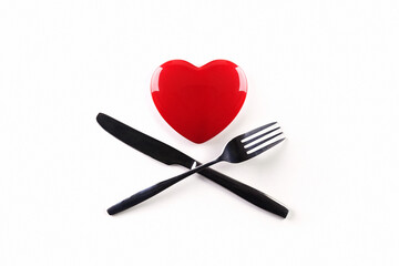 Red heart and crossed knife with fork on white background. The effect of food on the heart. Diet.