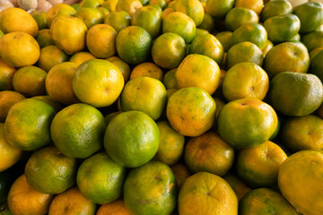 orange fruit stacked on the marketplace