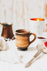 Coffee, toast and jam on a white wooden table