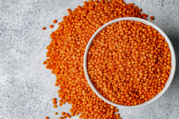 White ceramic bowl of red lentils on wooden table