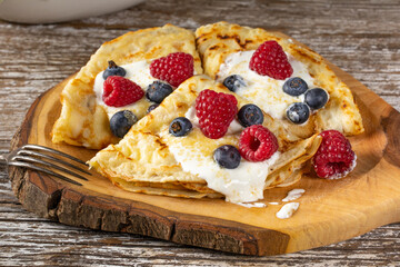Pancakes with white cheese and fruit.