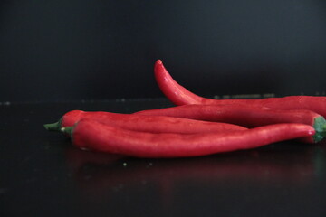 colorful peppers on a black background
