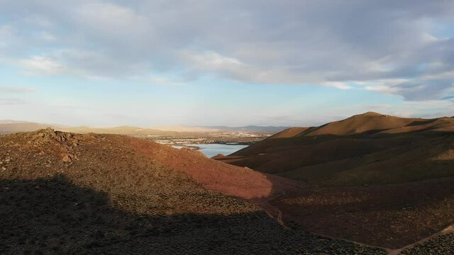  Fly over hiking trails and 4x4 roads towards a lake in the high desert mountains Stead Nevada.