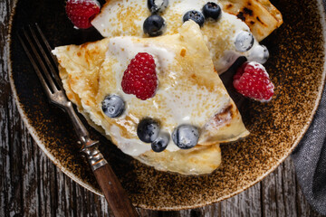 Pancakes with white cheese and fruit.