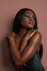 Fototapeta na wymiar Sensual African Woman. Vertical headshot isolated over colourful wall. Skin care treatment.