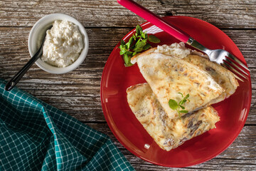 Crepes with ricotta cheese and blackcurrant jam.