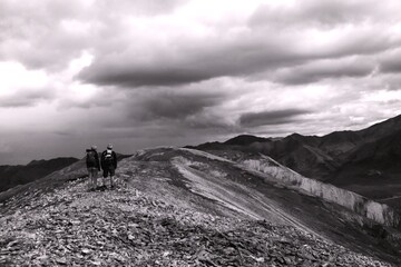 Hikers in the Mountains with clouds