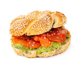 Sliced salmon with avocado on bagel with sesame seeds