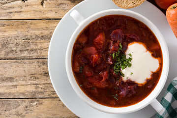 Traditional Ukrainian Russian borsch. Beetroot soup on wooden table.	