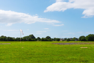 Beautiful long shot of a field used as a takeoff/landing runway for planes. Small airdrome in the...