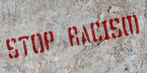 Stencil stop racism on an old concrete wall. Background. Collage. Concept.