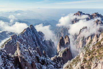 Clouds by the mountain peaks of Huangshan National park. China.