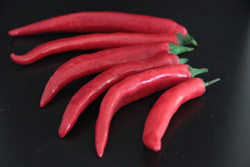 colorful peppers on a black background
