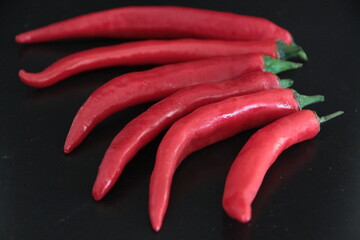 colorful peppers on a black background
