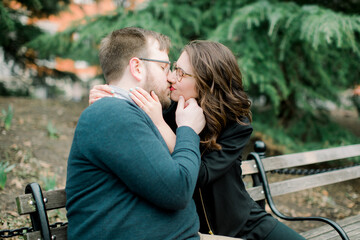 A couple in love having a romantic moment and showing mutual affection in a local urban park outdoors