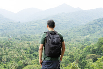 Fototapeta na wymiar Asian Traveler with Backpack Look through the Forest