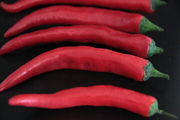 colorful peppers on a black background
