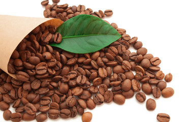 coffee beans in a cornet with green leaf on white background